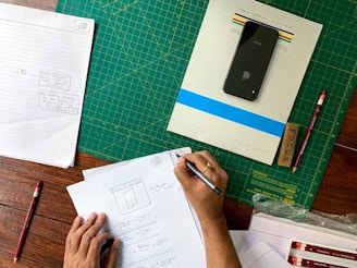 a person writing on a piece of paper