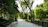 A sunlit park scene with a couple walking hand in hand, smiling freely.