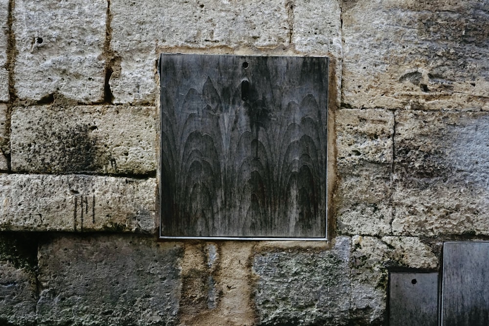 a picture of a window in a stone wall