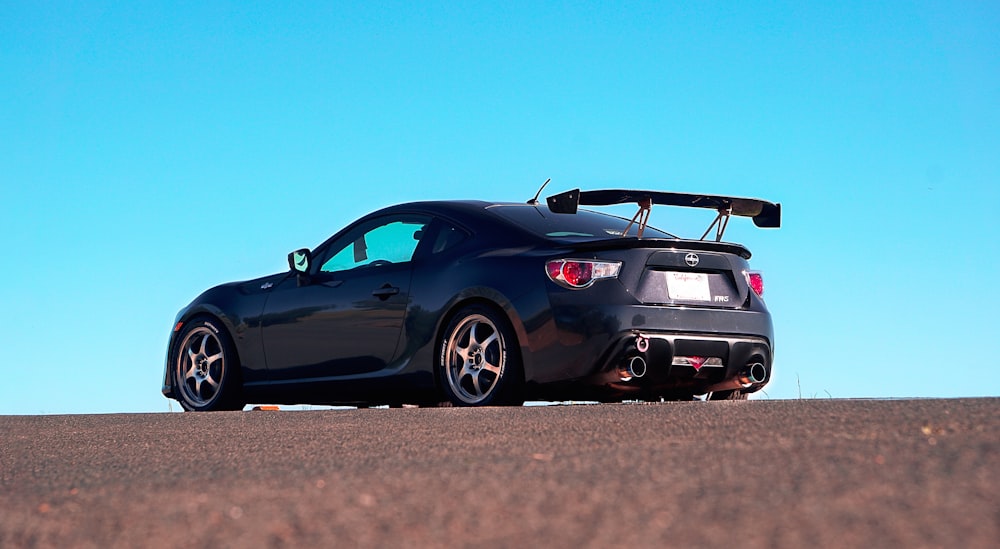 a black sports car parked on the side of the road