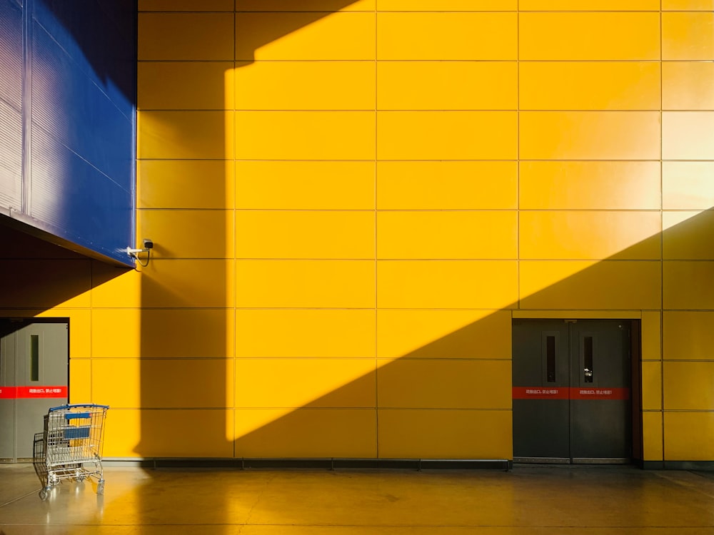 a yellow wall with a chair in front of it