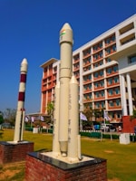 a large rocket sitting on top of a brick block
