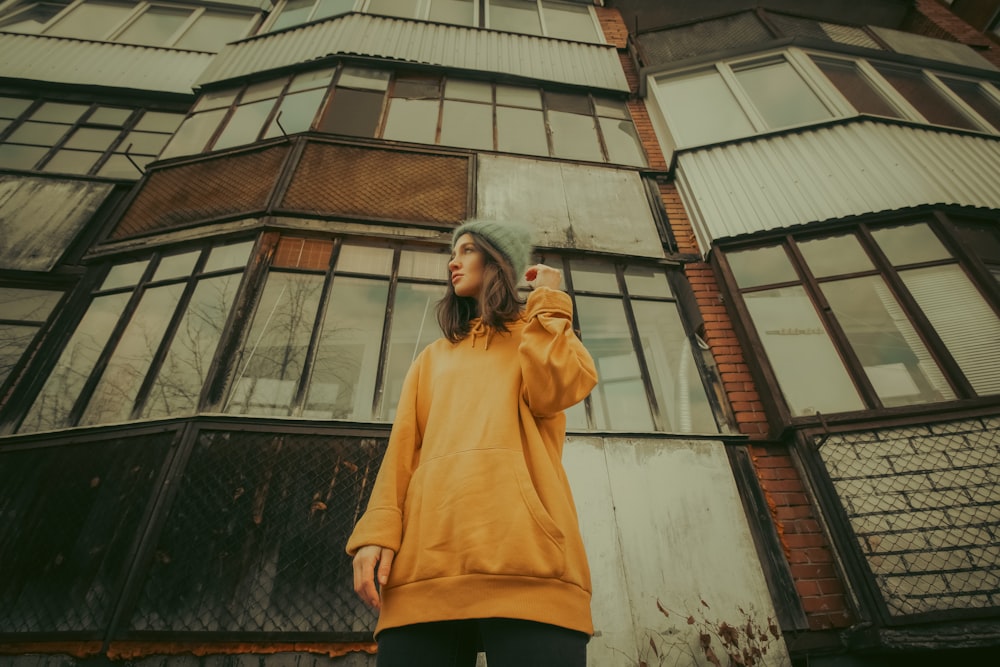 a woman standing in front of a tall building