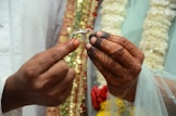 a man is holding a wedding ring in his hands