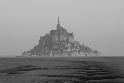 a large castle sitting on top of a sandy beach
