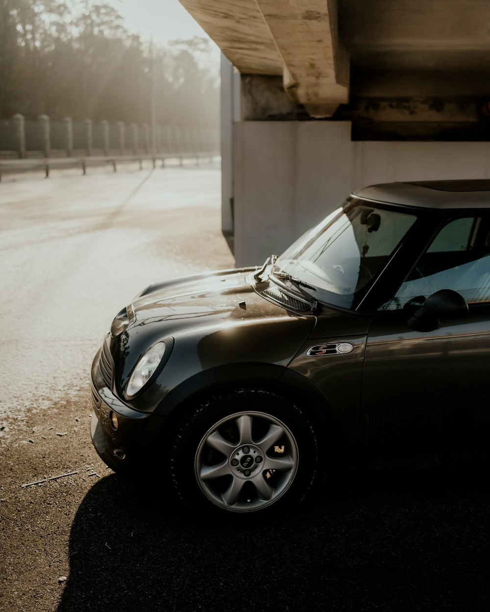 a small black car parked in front of a building