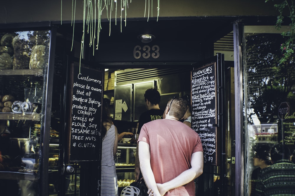 a man standing in a doorway of a restaurant