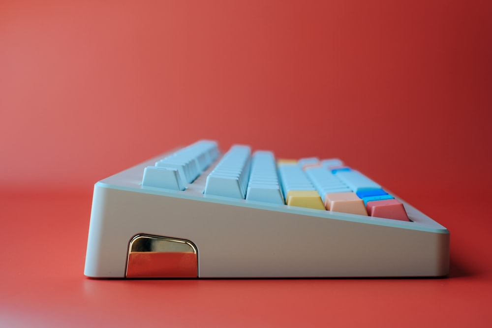 a computer keyboard sitting on top of a red table