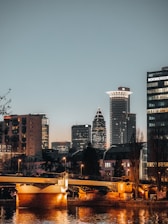 A sleek Düsseldorf cityscape at dusk highlighting modern architecture and the Rhine river.