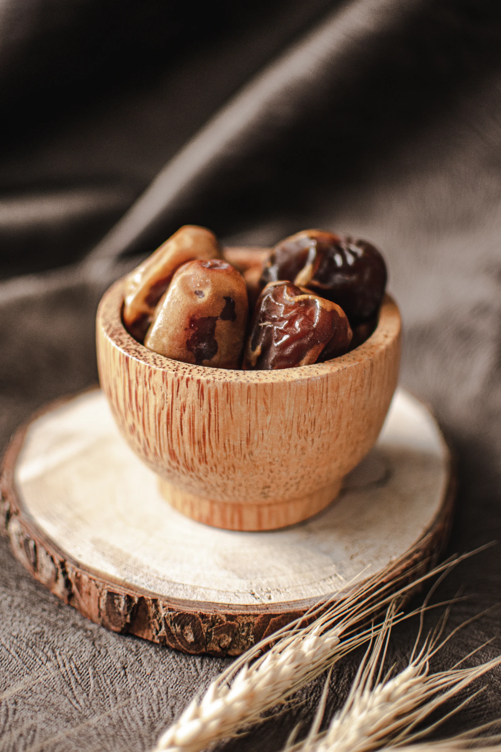Medjool dates heaped in a wooden bowl