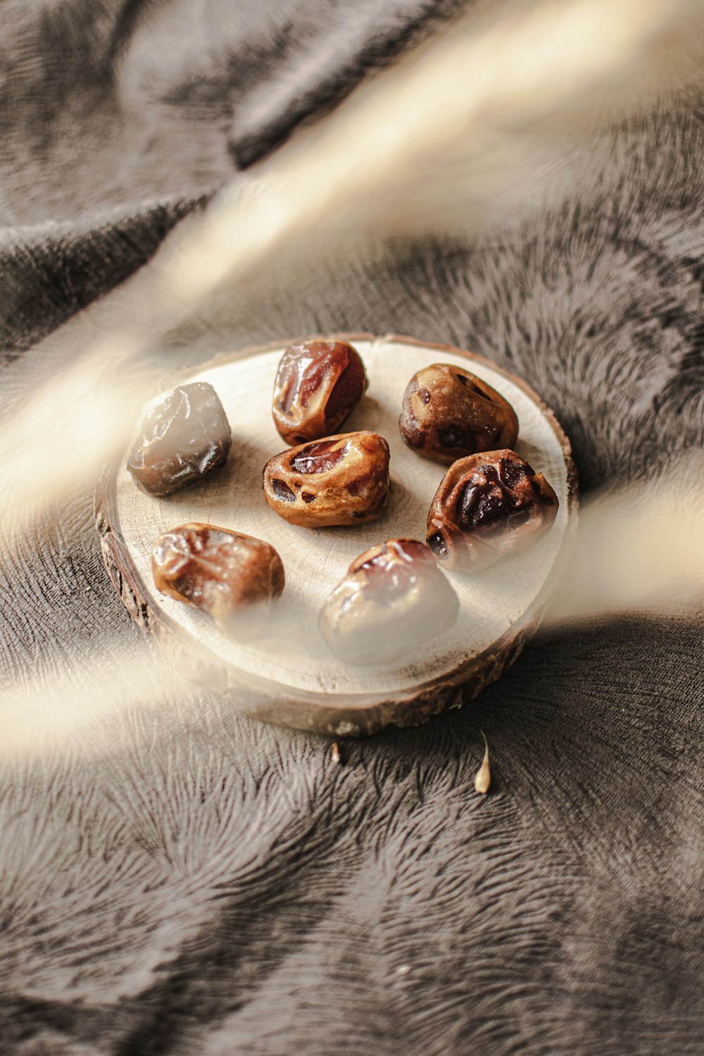 a plate of nuts sitting on top of a blanket