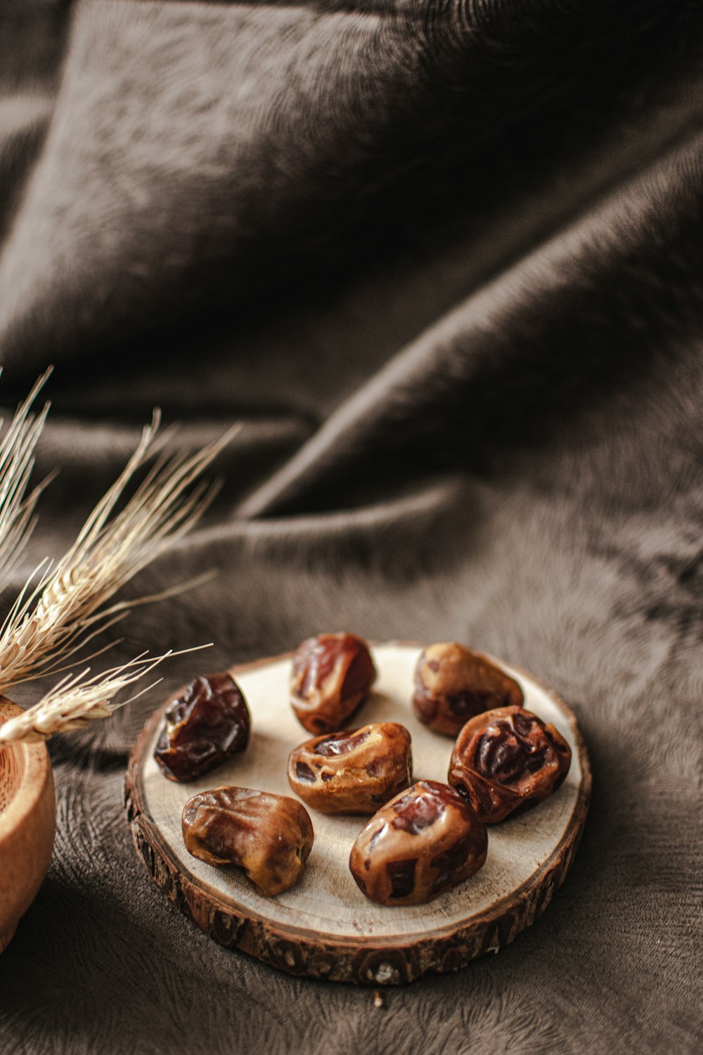 a plate of nuts on a wood slice