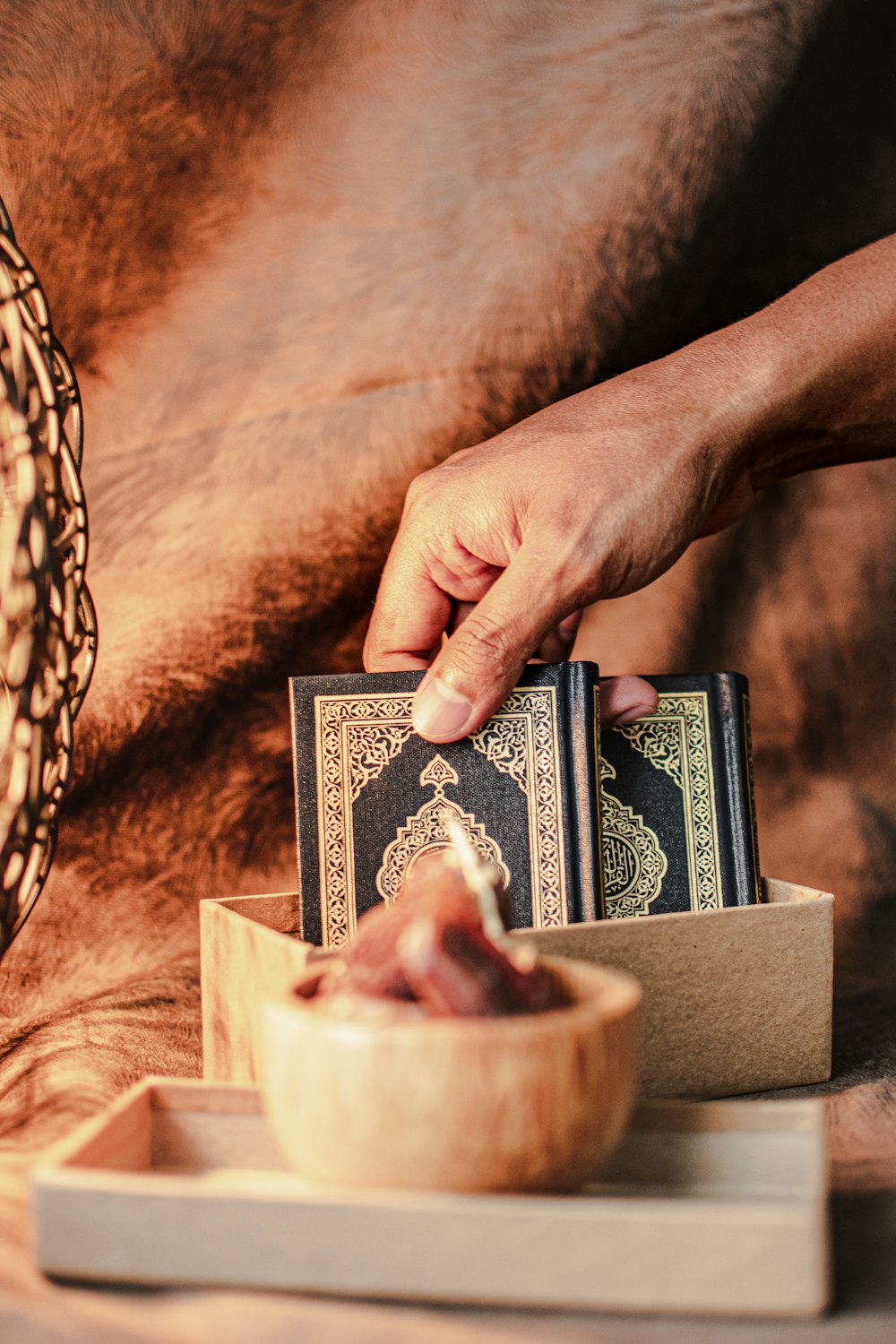 a person holding a book over a bowl of food