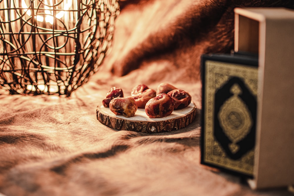 a plate of food sitting on a bed next to a book