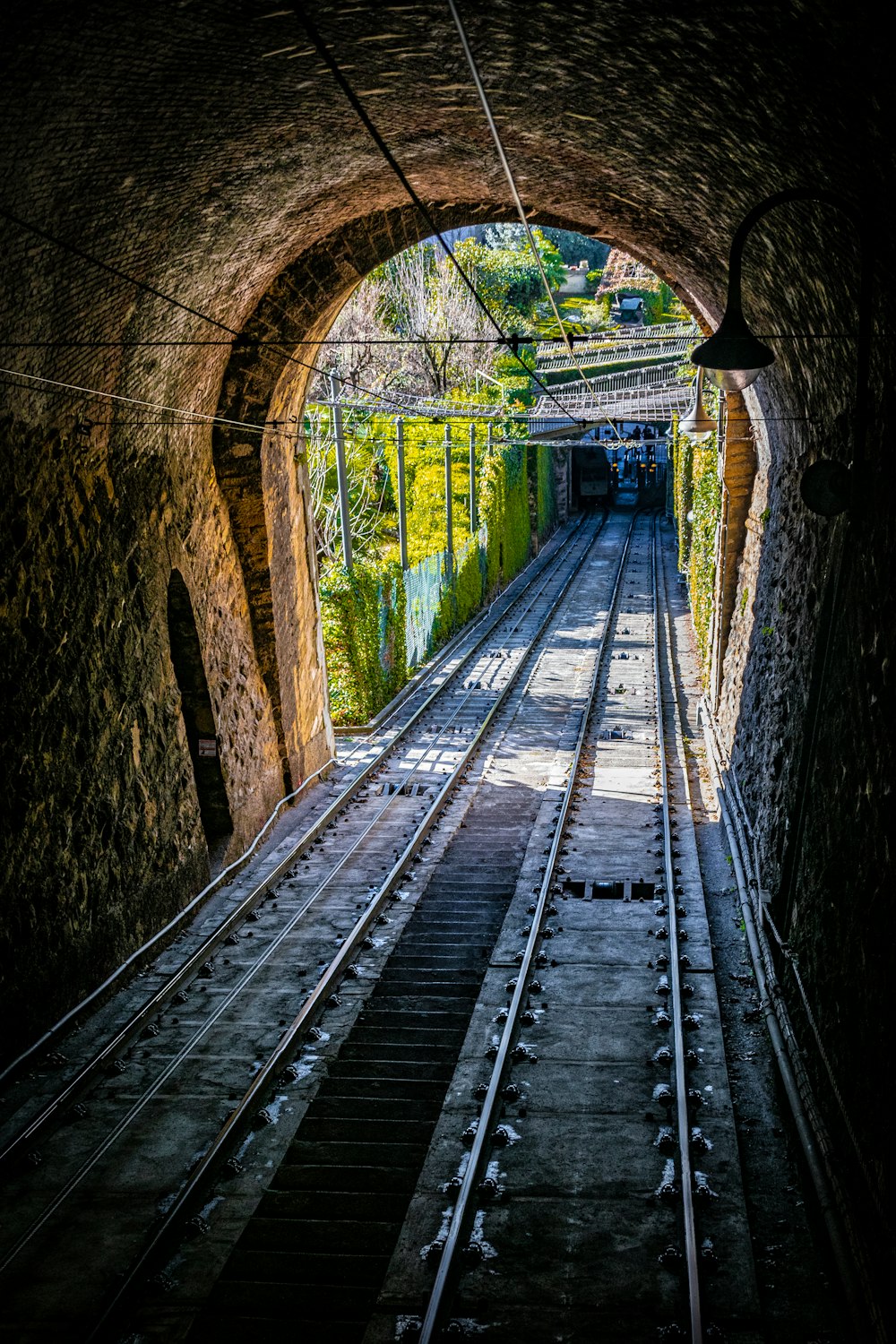 a tunnel with a train track going through it