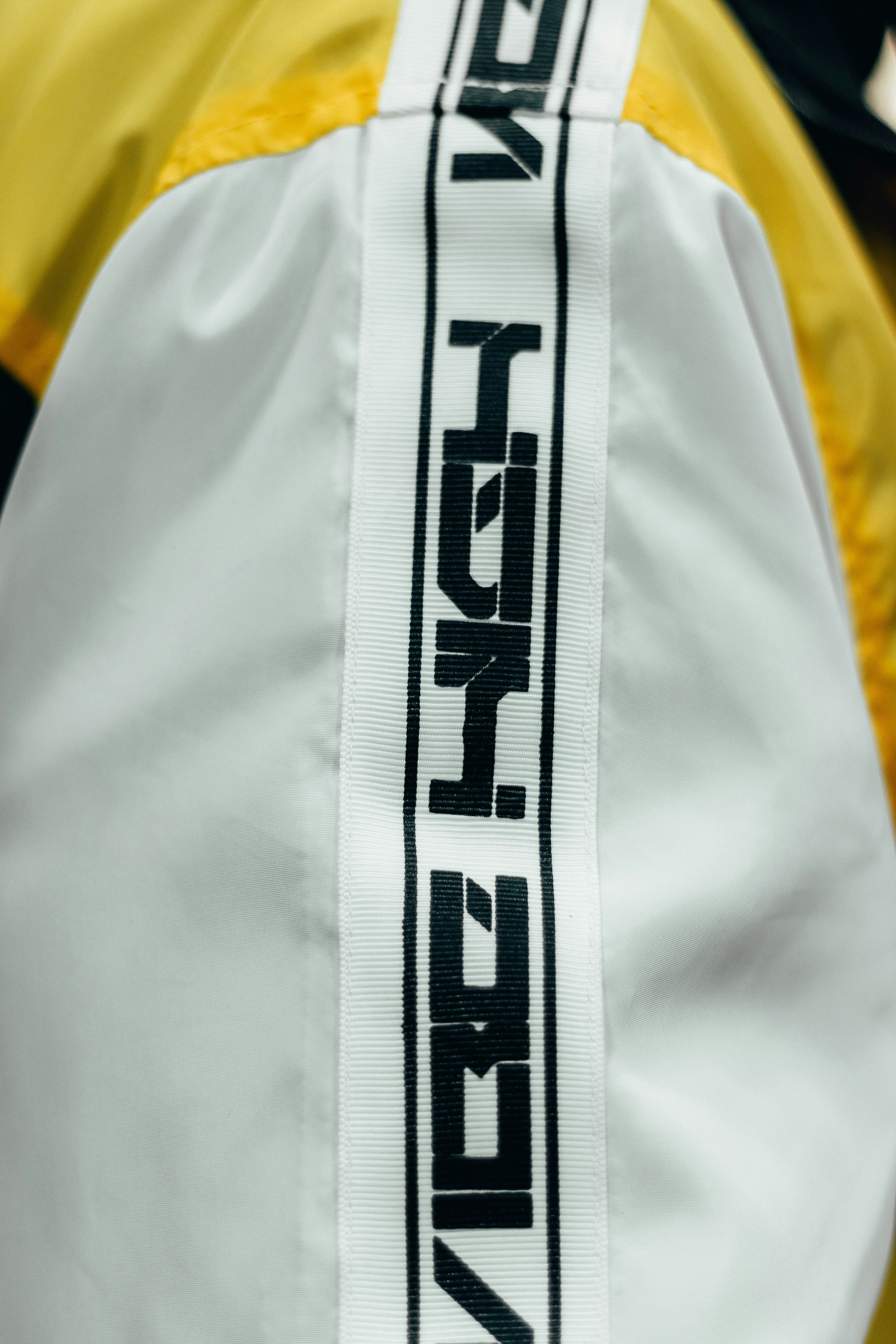 the back of a yellow and white jacket