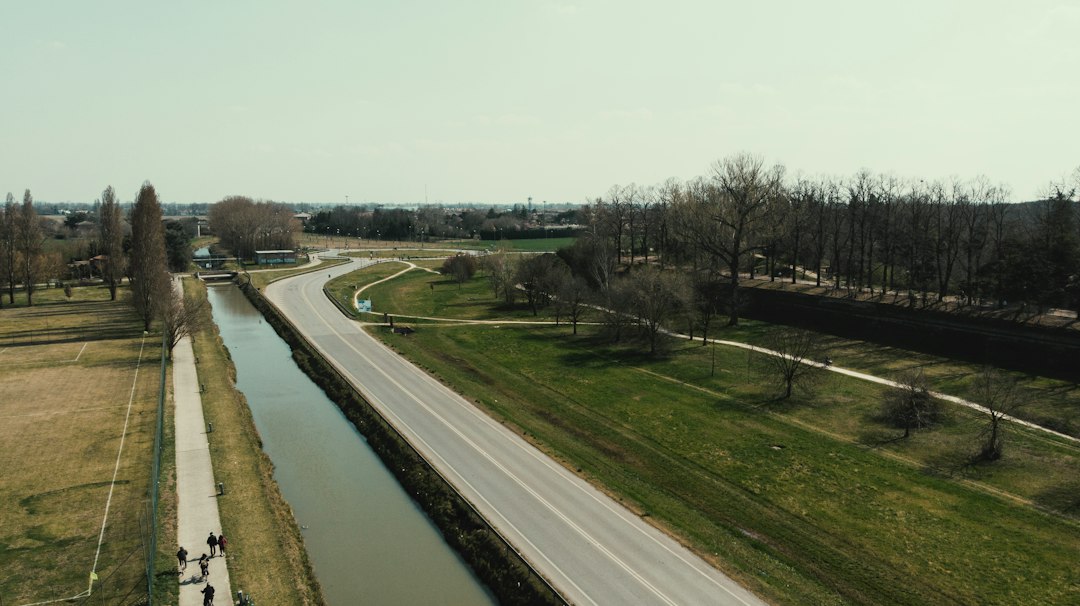 an aerial view of a road and a river