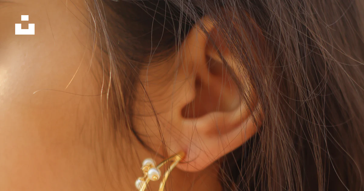 A close up of a person wearing a pair of earrings photo – Free ...