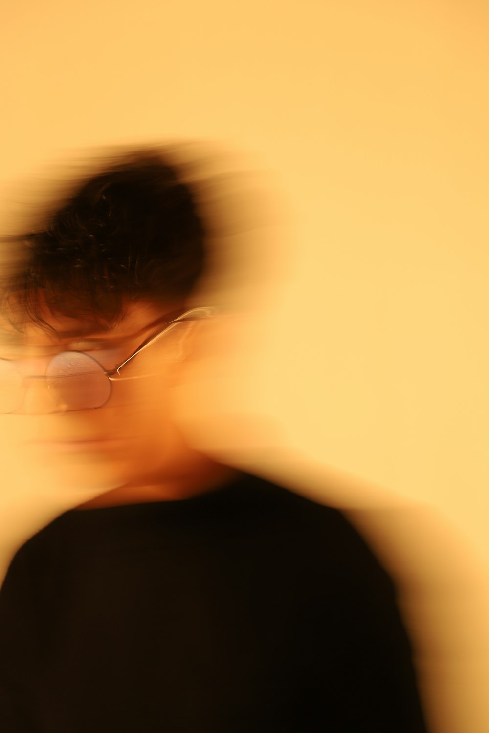 a blurry photo of a person wearing glasses