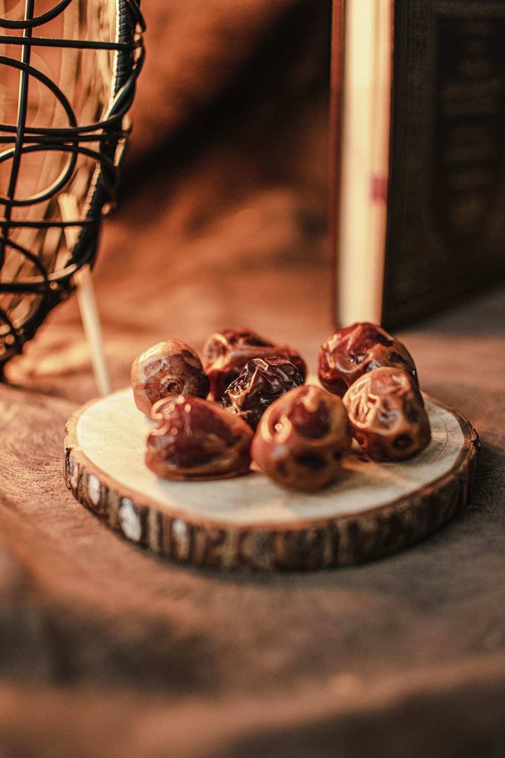 a plate of donuts sitting on a table next to a basket of books