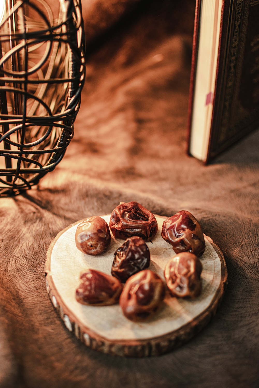 a plate of nuts sitting on a table next to a book