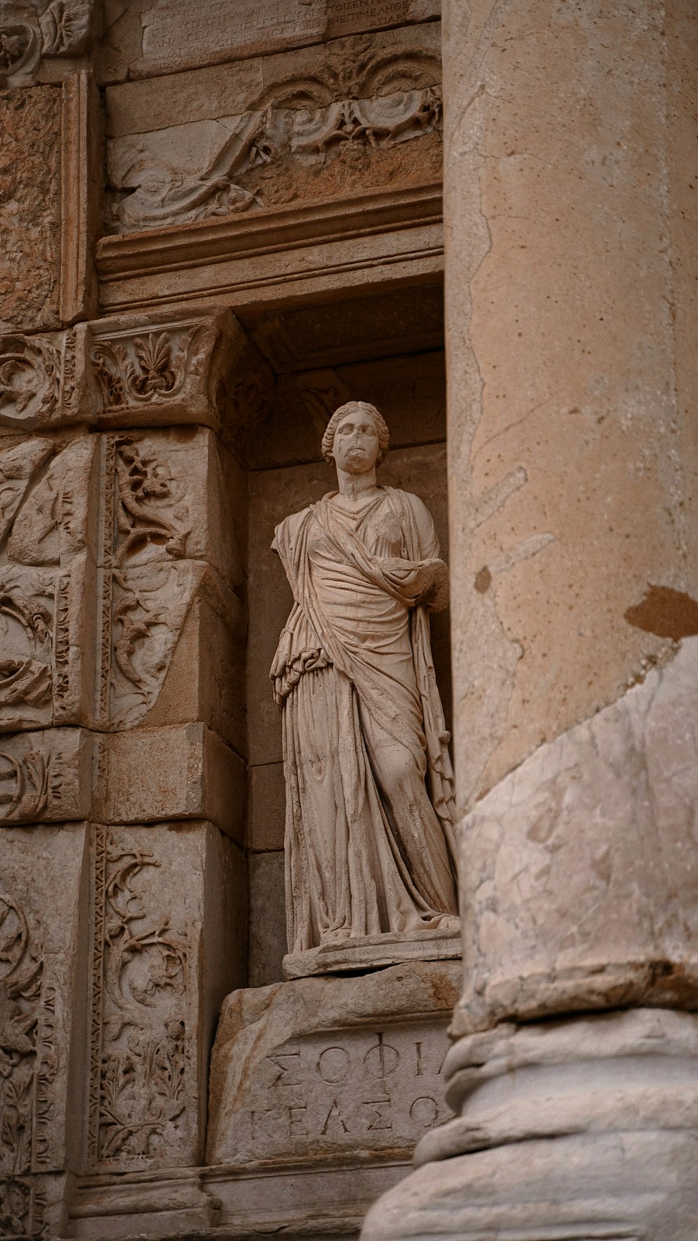 a statue of a woman standing in a doorway