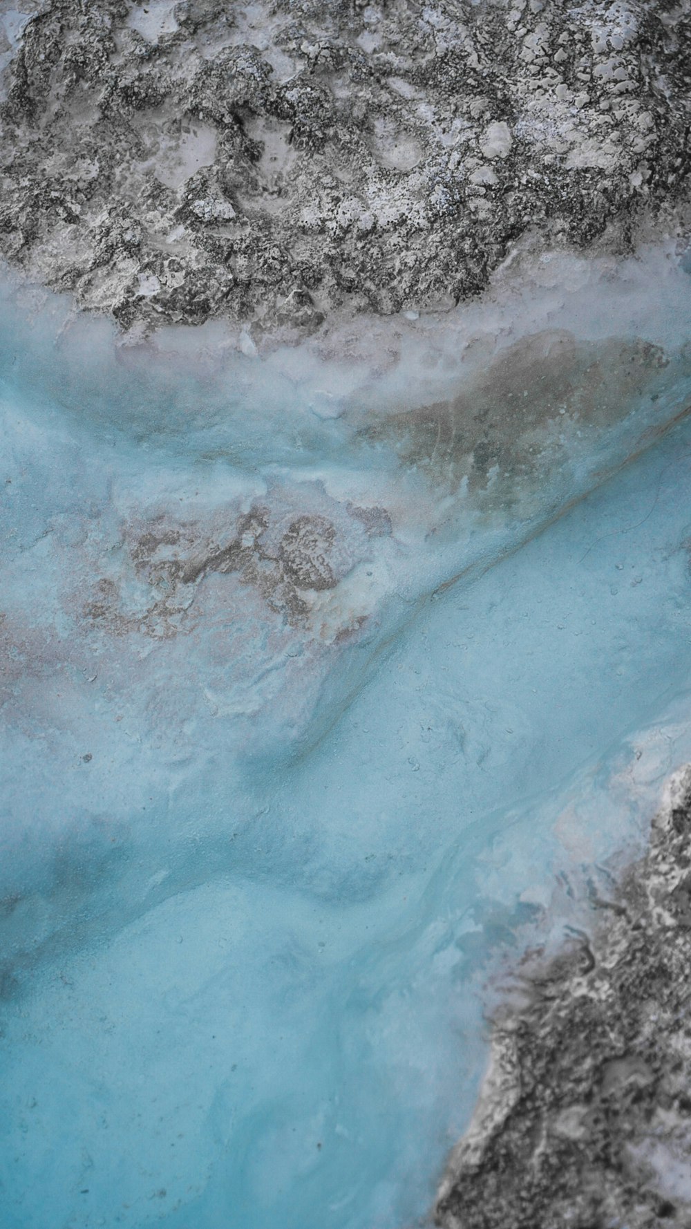 a close up of a blue substance in water
