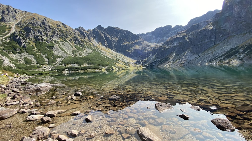 a body of water surrounded by mountains and rocks