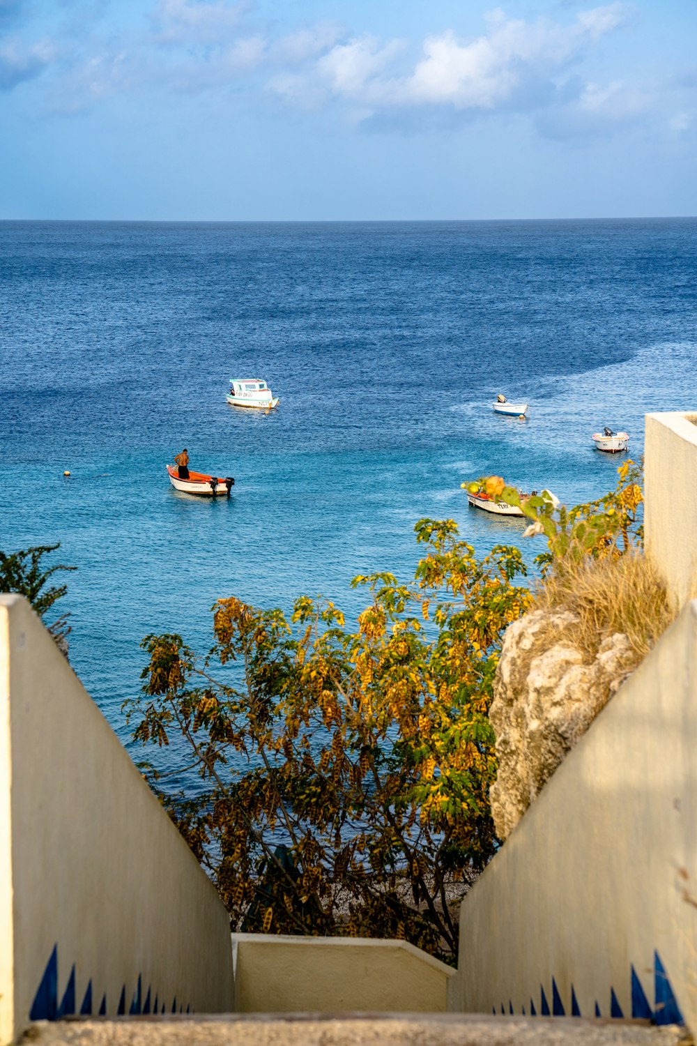 a couple of boats floating on top of a body of water