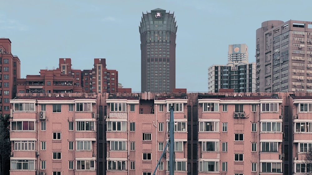 a very tall building with a clock tower in the background