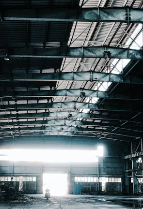 a man riding a skateboard inside of a warehouse