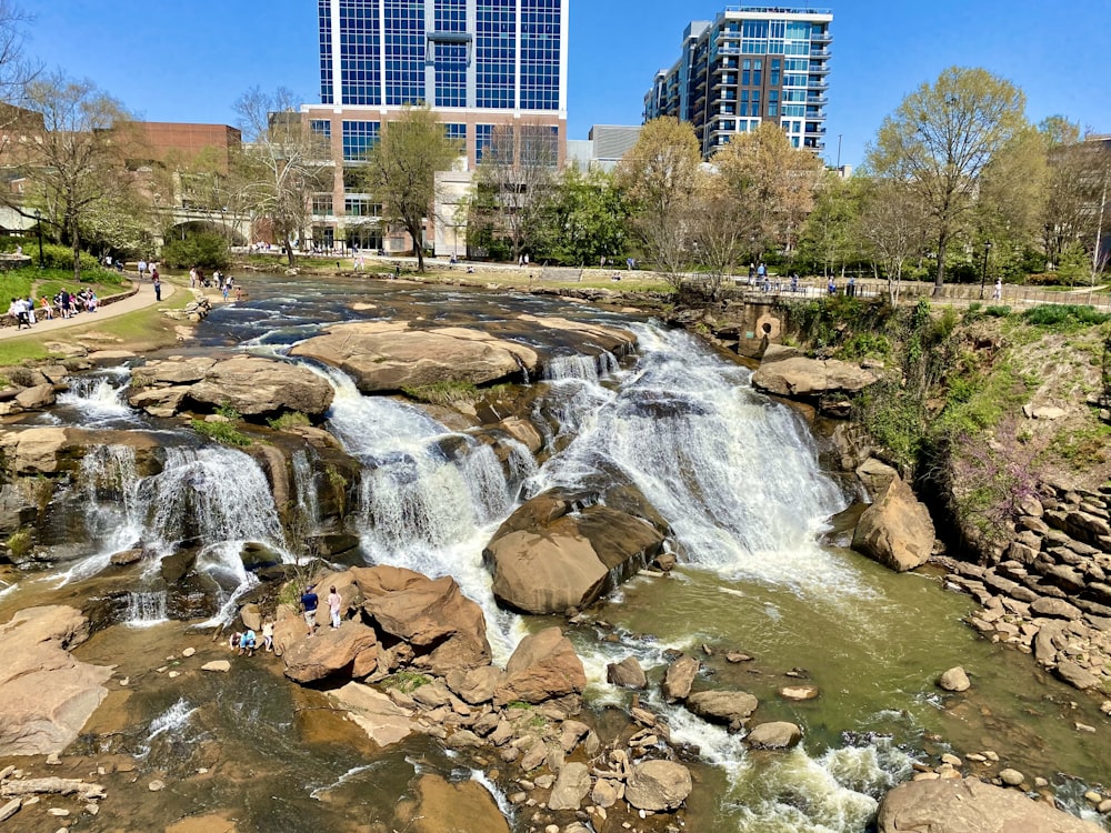 a waterfall in the middle of a city park