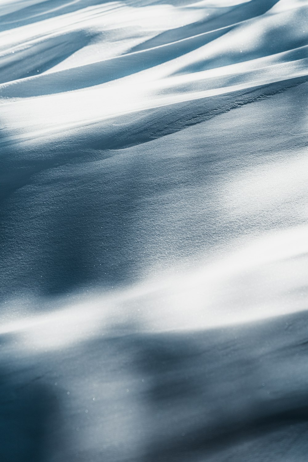 a snowboarder is going down a snowy hill