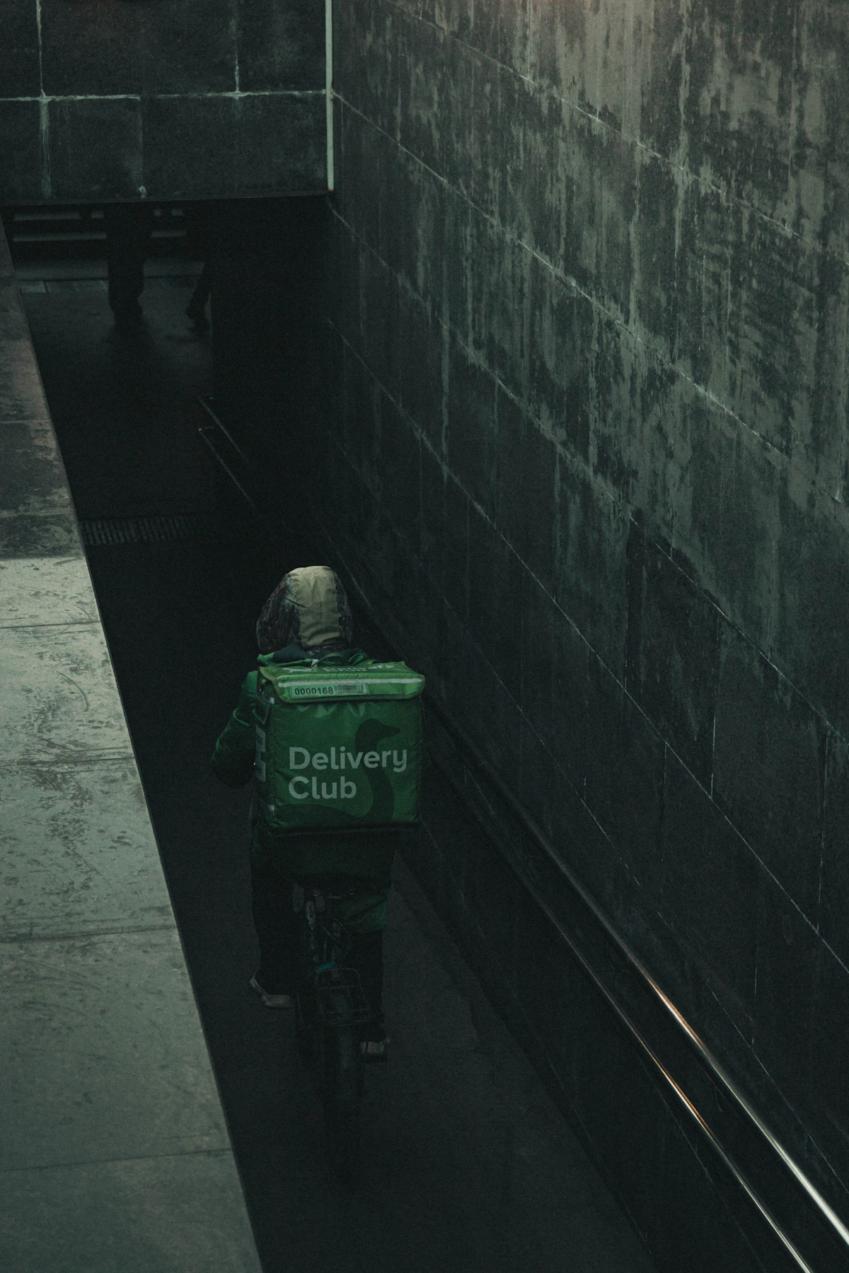 A person riding a bike with a delivery box on the back