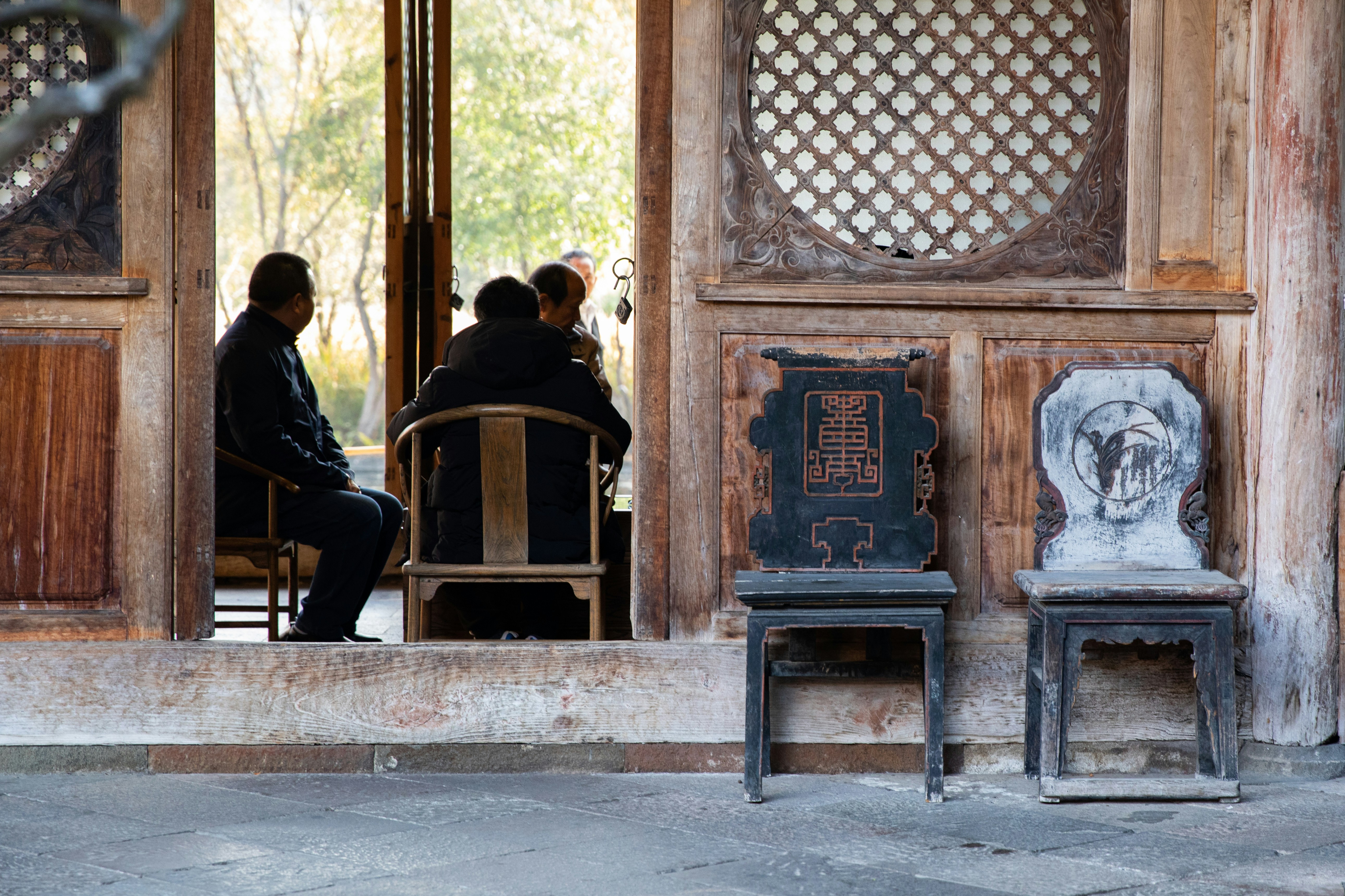 a couple of people sitting at a table in front of a building