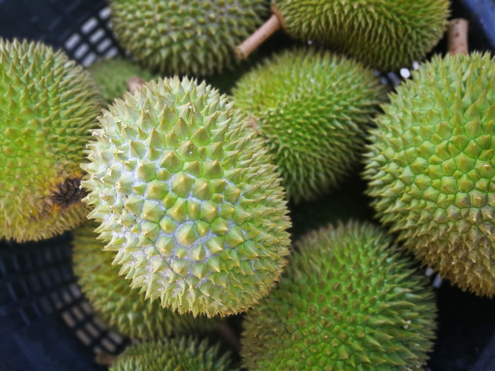 a close up of a bunch of fruit in a basket