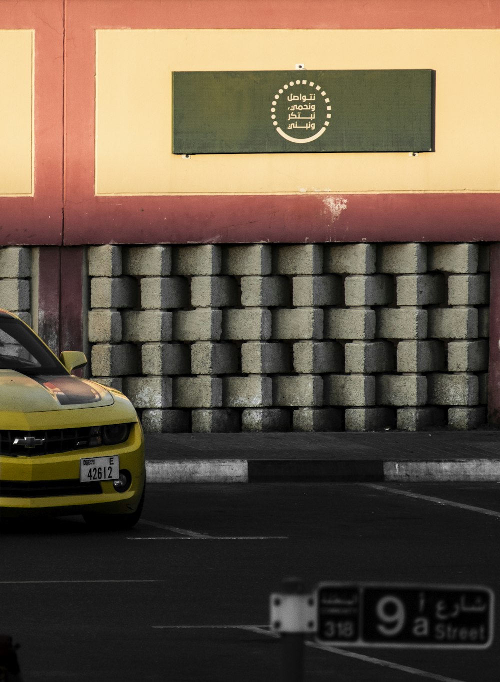 a yellow car is parked in a parking lot