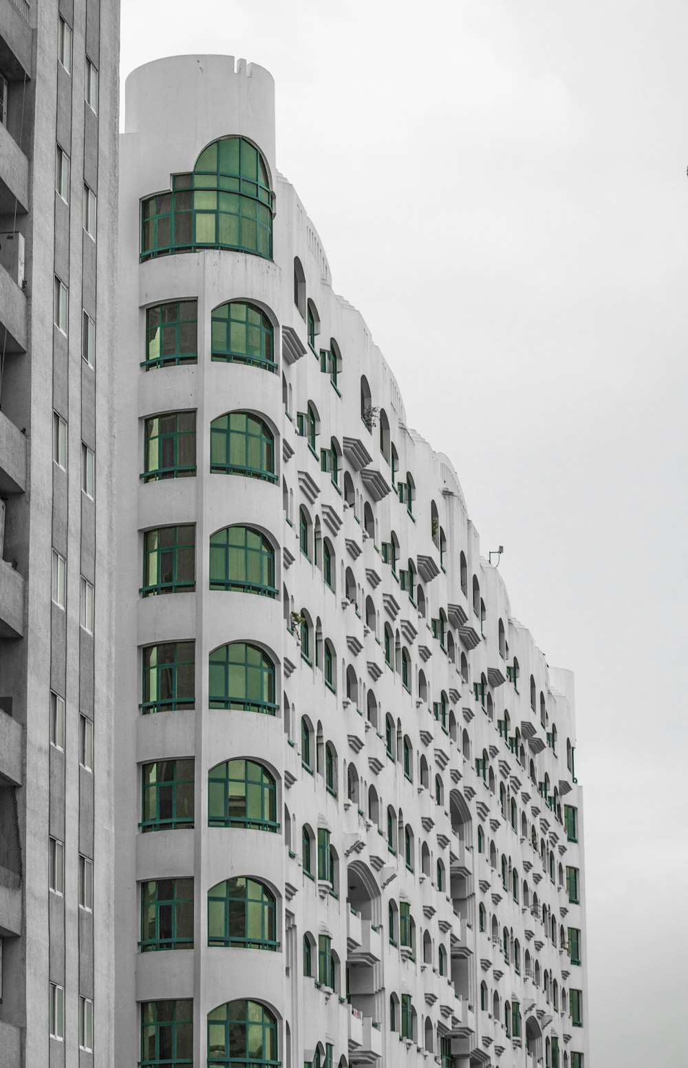 a tall white building with lots of windows