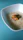 A bowl of steaming bran rice served with fresh vegetables on a rustic wooden table.