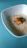 A bowl of steaming bran rice served with fresh vegetables on a rustic wooden table.