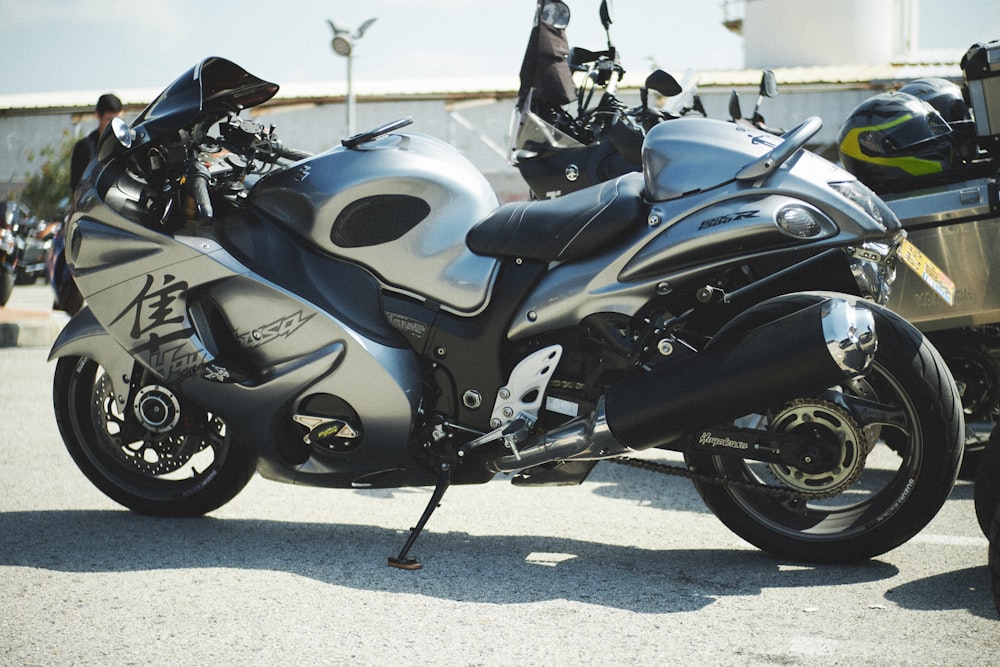 a silver and black motorcycle parked in a parking lot