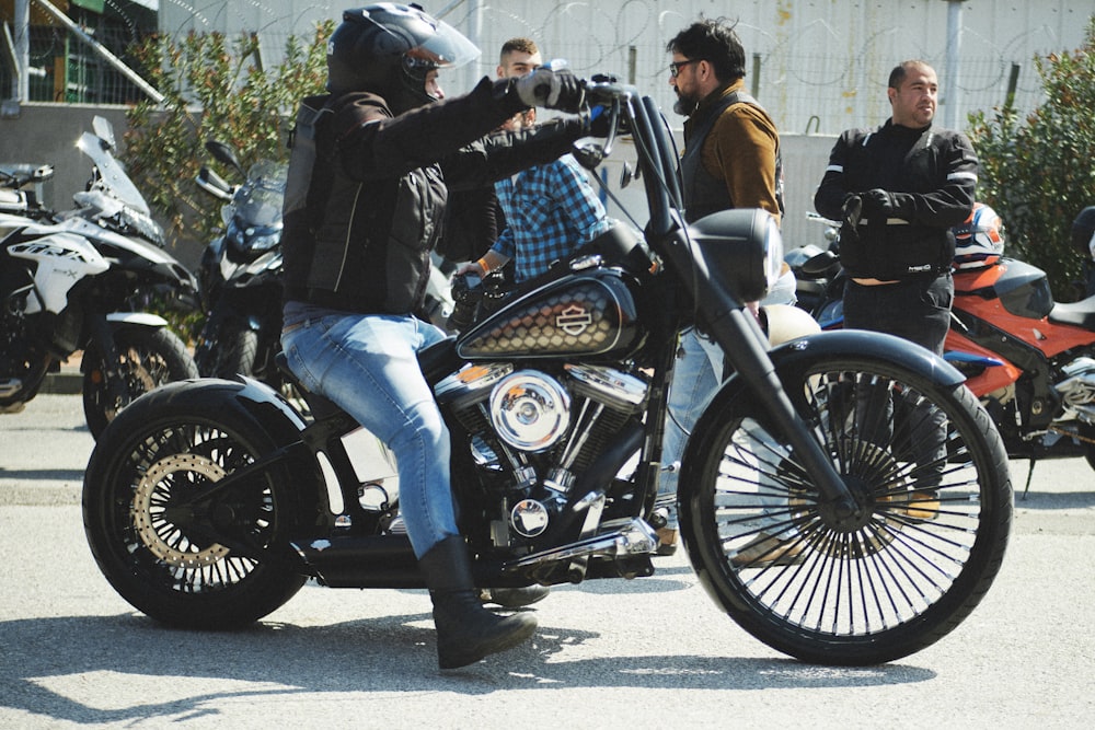 a man sitting on top of a motorcycle