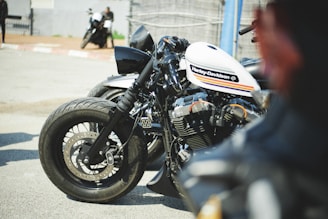 a white and black motorcycle parked in a parking lot