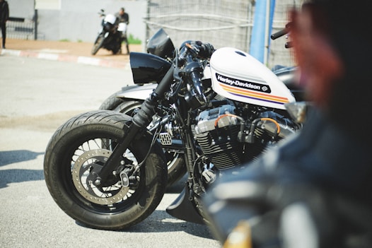 a white and black motorcycle parked in a parking lot
