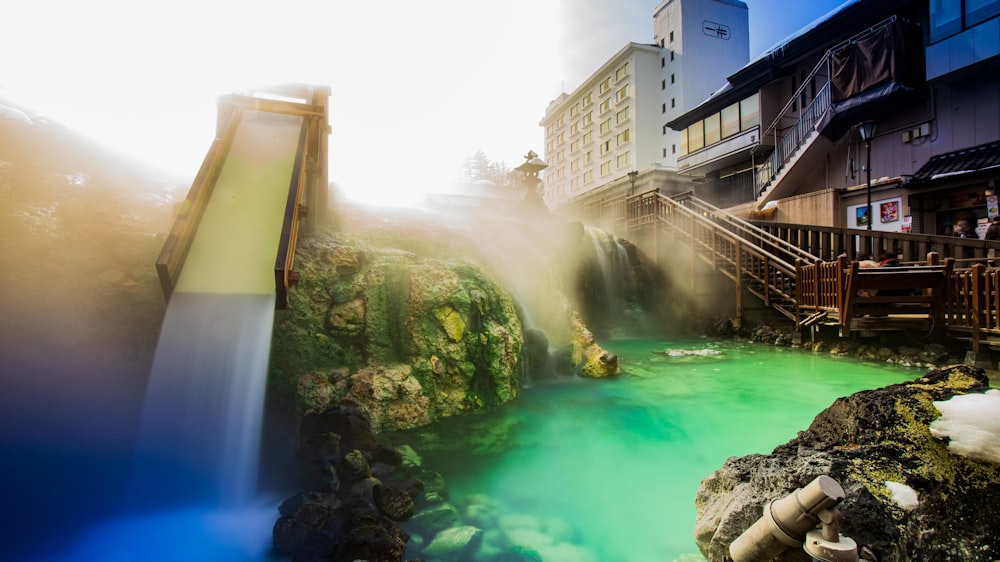 a water slide going down a river next to a building