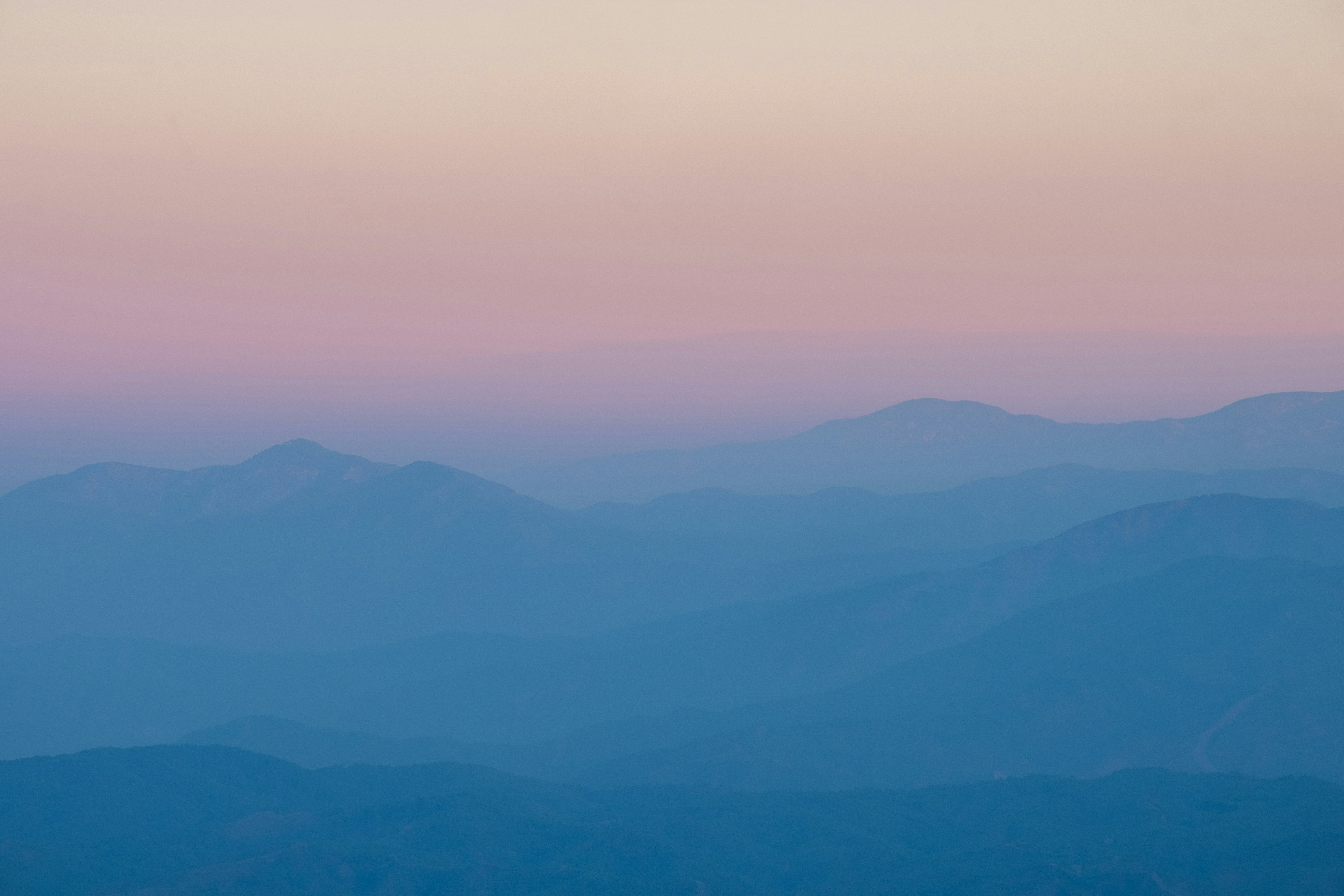 a view of a mountain range at sunset