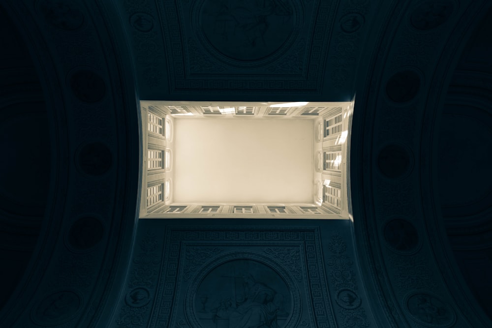 a ceiling with a square light in the middle of it