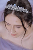 Close-up of The Empress’s crown adorned with stars, glowing softly.