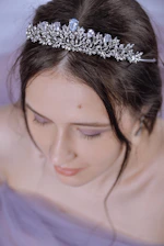 A close-up of a crowned Mrs India winner smiling confidently with a sparkling tiara.