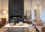 a living room filled with furniture and a fire place